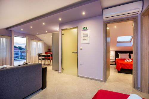 a room with a bed and a door leading to a bedroom at Dorothea Suite in Potos
