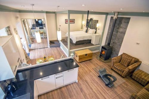 a kitchen and living room with a bed and a couch at Owls Nest in Edinbane