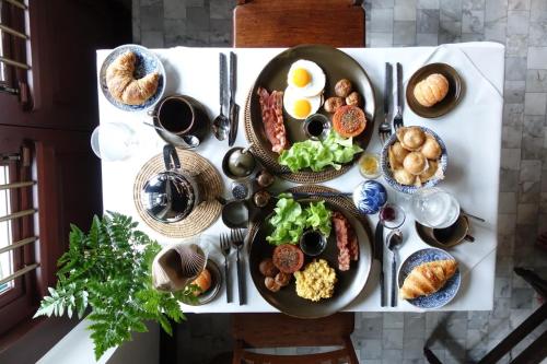 a table with plates of breakfast food on it at 1905 Heritage Corner in Bangkok