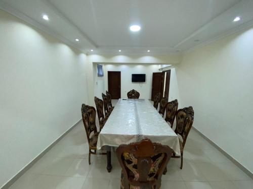 a long dining room with a table and chairs at Bahri Tojik Resort & Spa in Kairakum