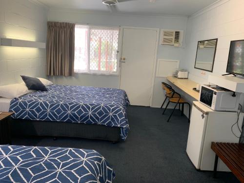 a hotel room with a bed and a desk at Classic Motel in Gold Coast