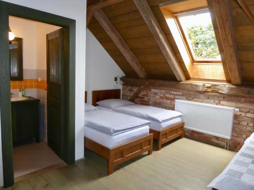 a bedroom with two beds and a window at U Devíti vidlí in Žlutice