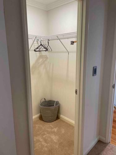 a room with a hallway with a basket and a wall at Canal Vista in Mandurah