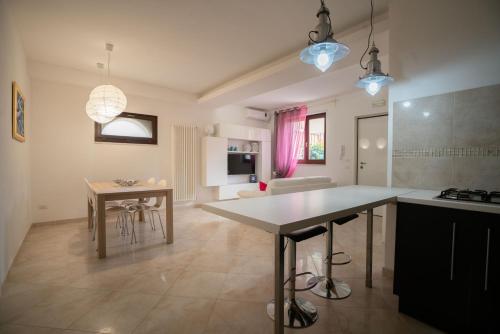 a kitchen and living room with a counter and a table at La Casetta di Chiara B&B in Polignano a Mare