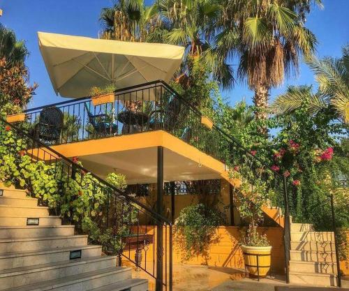 a house with stairs with plants and palm trees at STELLA HOTEL&Spa ALL INCLUSIVE in Kemer