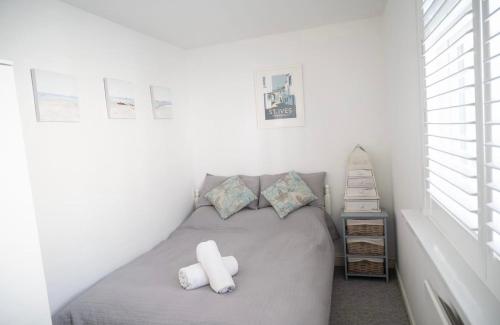 a bedroom with a gray bed with two pillows at Sunnyside - Back Road East St Ives - Sleeps 4 in St Ives