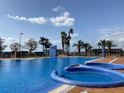 een groot zwembad met blauw water bij Albatross Mobile Homes on Camping El Pla de Mar in Malgrat de Mar