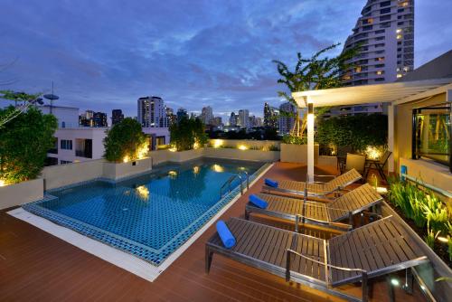 a swimming pool on the roof of a building at Ramada Ekamai in Bangkok