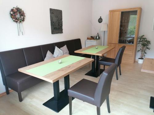a dining room with two tables and chairs at Ferienweingut Hensler in Briedel