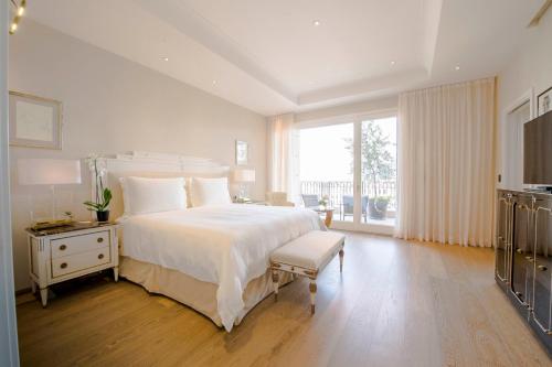 a bedroom with a white bed and a white dresser at Palazzo Parigi Hotel & Grand Spa - LHW in Milan