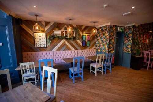 a restaurant with a table and chairs in a room at The Waverley Hotel in Callander