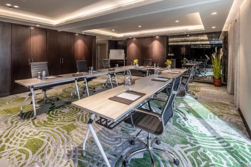 a large conference room with long tables and chairs at Somerset Downtown Al Khobar in Al Khobar