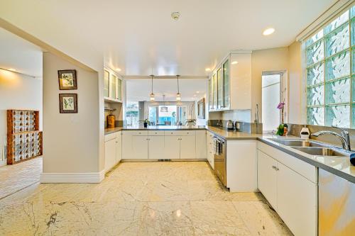 a large kitchen with white cabinets and a large window at Luxury in Malibu in Malibu