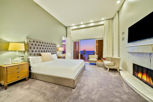 a bedroom with a large bed and a tv at Luxury in Malibu in Malibu