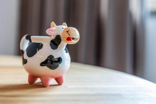 a small toy cow pitcher sitting on a table at Studio Alpendomizil Ahorn in Mayrhofen