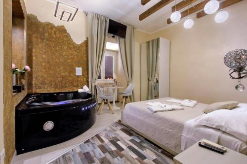 a hotel room with a bed and a bath tub at Suite Paradise Rome Guest Rooms in Rome