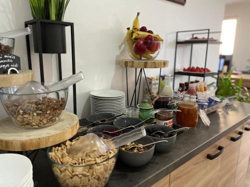 a buffet with bowls of food on a counter at Villa Aruba & Private SPA Suites in Keszthely