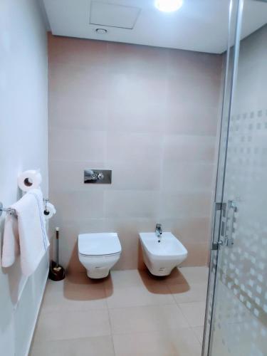 a bathroom with a toilet and a sink and a shower at La Marina Luxury Apartment Fully Furnished Free WiFi, High Standard Residence, Amazing Prime Location Close to Restaurants, Transport, Beach and Bouregreg River in Sale