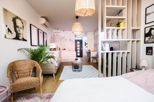 a bedroom with a bed and a living room at V10 B Apartment in Pécs