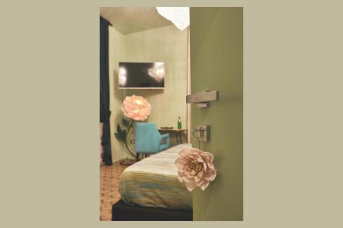 a bedroom with a bed with a pink flower on the door at Le Stagioni Luxury Suite in Forlì