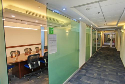 an office with a hallway with chairs and a desk at Holiday Inn Leon by IHG in León
