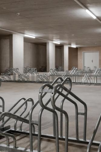 a row of metal chairs in an empty room at Los Lorentes Apartments Bern City in Bern
