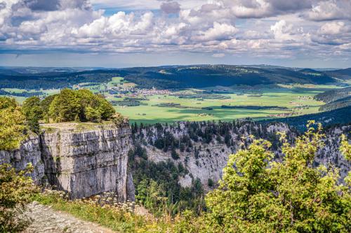 a view of the blue mountains from the top of a mountain at Hotel Palafitte in Neuchâtel