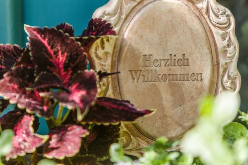 a mirror with some flowers in front of it at Landhaus Hindenburg in Bad Gleichenberg