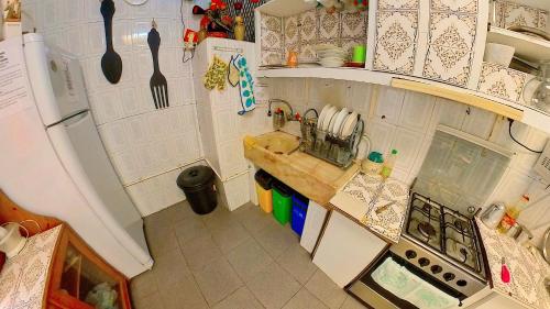 a kitchen with a sink, stove, and cabinets at M2Students Hostel in Porto