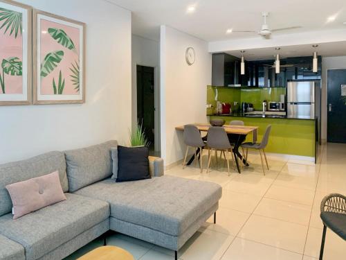 a living room with a couch and a table at Darwin City Chic@Kube Apartments in Darwin