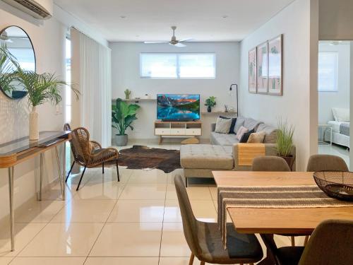 a living room with a couch and a table at Darwin City Chic@Kube Apartments in Darwin
