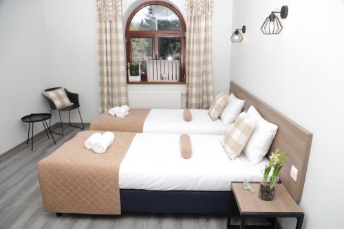 a bedroom with two beds and a window at Hotel Do Poduchy in Zawiercie