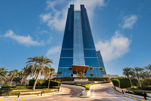 a large building with a clock on the top of it at Dusit Thani Abu Dhabi in Abu Dhabi
