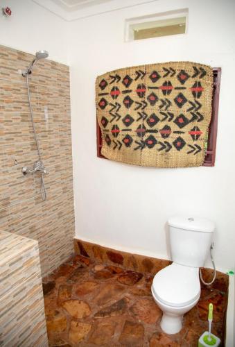a bathroom with a toilet and a shower at GKAT Resort in Mbarara