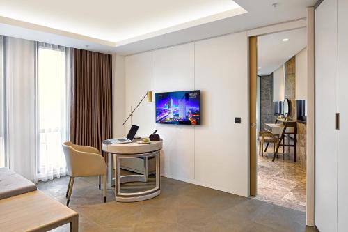 a room with a desk and a tv on a wall at Wanda Vista Istanbul in Istanbul