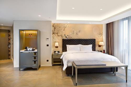 a bedroom with a large bed and a table at Wanda Vista Istanbul in Istanbul