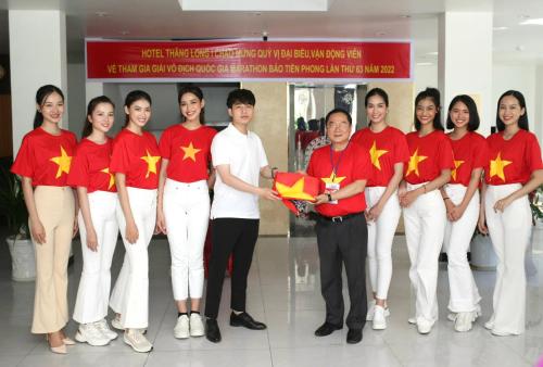 a group of people in red shirts holding chinese flags at Thăng Long Hotel in Con Dao