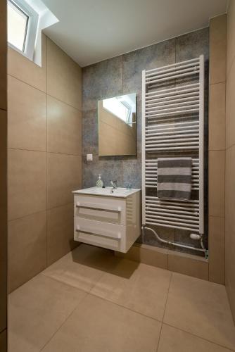 a bathroom with a sink and a mirror at Hostel 26 in Košice