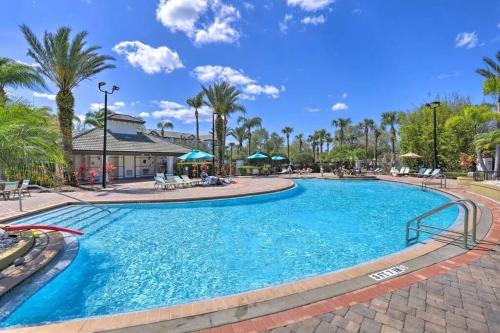 a swimming pool at a resort with palm trees at SeaworldDisneyUniversal Villa 5 beds 3 bed2bath in Orlando