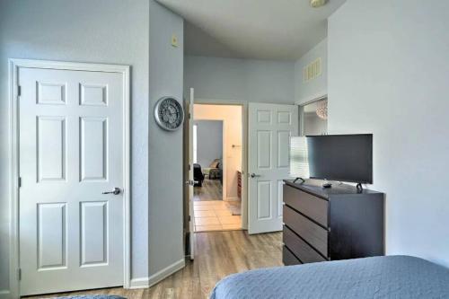 a bedroom with a bed and a television on a dresser at SeaworldDisneyUniversal Villa 5 beds 3 bed2bath in Orlando