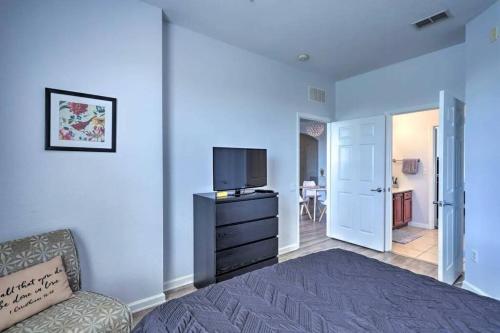 a bedroom with a bed and a tv and a chair at SeaworldDisneyUniversal Villa 5 beds 3 bed2bath in Orlando