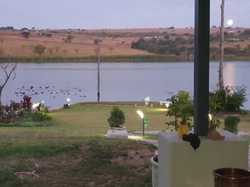 a view of a lake with birds in the distance at Goggas Nest BNB & Restaurant in Matsapha