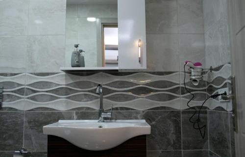 a bathroom with a sink and a mirror at Sare House in Istanbul