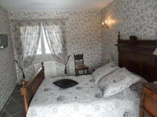 a bedroom with a bed and a chair and a window at Beautiful HOUSE in Trouville / Swimming Pool 12 persons in Trouville-sur-Mer
