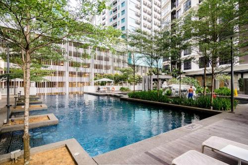a swimming pool in the middle of a city at Maxhome at Fraser Residence KL in Kuala Lumpur