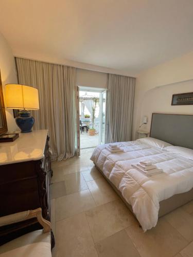 a bedroom with a bed and a desk with a lamp at Villa le stelle capri in Capri