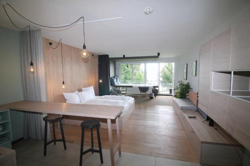 a bedroom with a bed and a table and a desk at Junior-Suite am See in Ascheberg