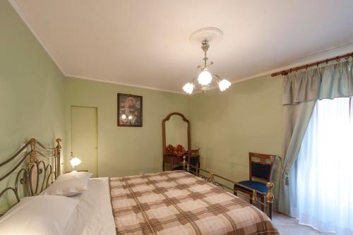 a bedroom with a bed and a mirror and a window at La Casa dei Nonni B&B in Scanno