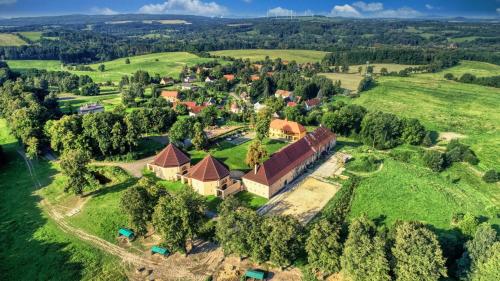 an aerial view of a house on a green field at Zámecký Dvůr Černousy in V Poli