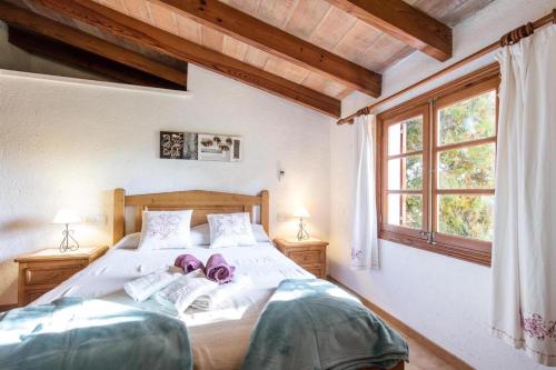 ein Schlafzimmer mit einem Bett mit zwei Schuhen drauf in der Unterkunft Fontxica in El Port